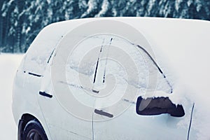 Frozen car covered snow in winter day
