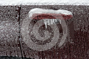 Frozen car door closeup, icicles, ice crystals, jammed lock