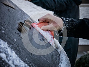 Frozen car with ice crust being scraped