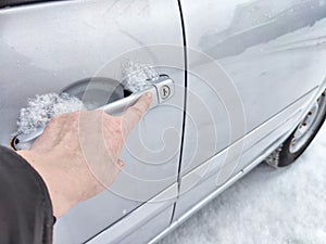 Frozen Car Lock on a Cold Winter Day. Woman person attempts to unlock a frozen car door, showing the challenges faced