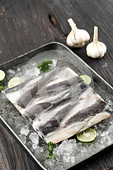 Frozen Catfish Fillet on Tray with Sliced Lime and Crushed Ice