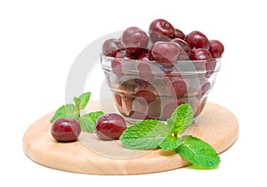 Frozen cherries and mint on white background