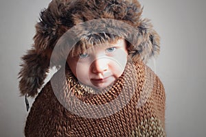 Frozen child in fur Hat.fashion winter style.little boy.children.cold