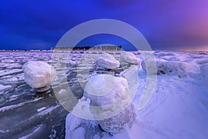 Frozen coastline of Baltic Sea in Gdynia at night