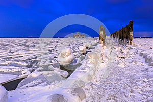 Frozen coastline of Baltic Sea in Gdynia at night