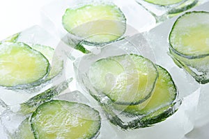 Frozen cucumber slices in the ice cubes photo
