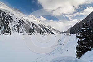 Frozen dam lake in the Alps