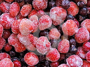 Frozen delicious berries on blue background, closeup.