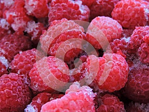 Frozen delicious berries on blue background, closeup.