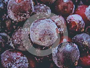 Frozen delicious berries on blue background, closeup.