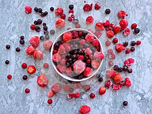 Frozen delicious berries on blue background, closeup.