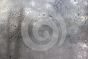 Frozen drops on frosted glass. Winter textured background.