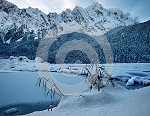 Frozen Eibsee river surrounded by trees covered with snow in Bavaria, Germany