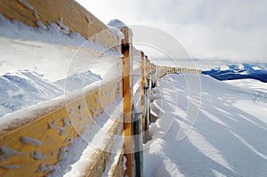 Frozen fence in mountain peak