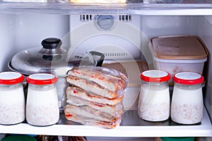 Frozen food in the freezer. Concept of storing ready made dinner and saving time