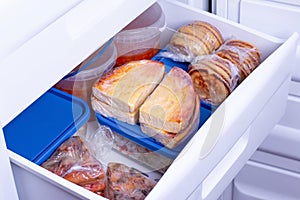 Frozen food in the freezer. Concept of storing ready made dinner and saving time