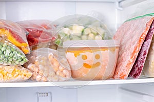 Frozen food in the freezer. Frozen vegetables, soup, ready meals photo