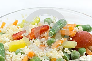 Frozen food: mix of couscous, vegetables and sauce closeup