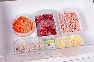 Frozen food in the refrigerator. Vegetables on the freezer shelves