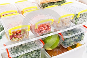 Frozen food in the refrigerator. Vegetables on the freezer shelves. photo
