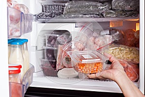 Frozen food in the refrigerator. Vegetables on the freezer shelves. Stocks of meal for the winter.