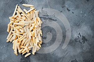 Frozen French fries potatoes, on gray background, top view flat lay , with copyspace  and space for text