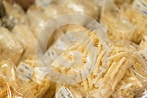 Frozen french fries in a supermarket packaged in a plastic bag.