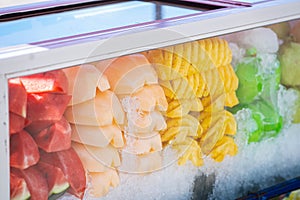 Frozen fruit trimmed ice in a glass cabinet for sale