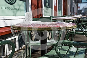 Frozen glass on the table covered with ice, outside of a restaurant in Reykjavik, Iceland photo