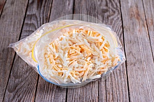 Frozen grated cheese in a package on the table