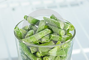 Frozen green beans in a glass in the freezer