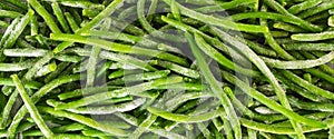 Frozen green beans, haricots verts, close up from above. Fresh raw vegetable food background photo