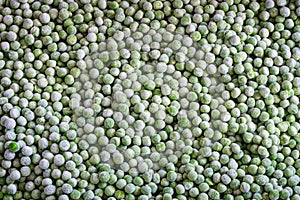 Frozen green peas background, frozen vegetables, top view photo