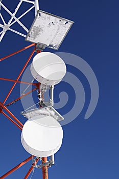 Frozen GSM antenna in blue sky photo