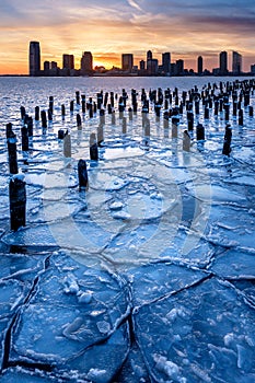 Frozen Hudson River, wood pilings and Jersey CitySkyscrapers at