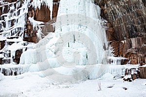 Frozen ice on rocks from a waterfall in the mountains