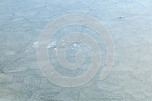 Frozen ice surface with natural patterns and subtle textures in winter