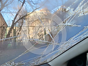 Frozen icy car windshield in late autumn or winter, view from inside