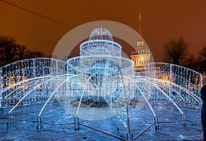 Frozen illuminated fountain in front of Admiralty building, Saint Petersburg, Russia