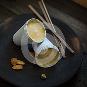 Frozen Kulfi in the moulds on rustic background.