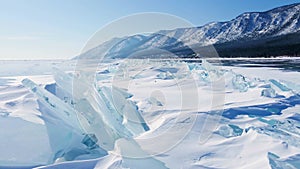 Frozen Lake Baikal, Aerial view. Beautiful winter landscape with clear smooth ice. Famous natural landmark Russia. Blue