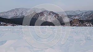 Frozen Lake Baikal, Aerial view. Beautiful winter landscape with clear smooth ice. Famous natural landmark Russia. Blue