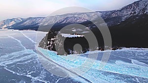 Frozen Lake Baikal, Aerial view. Beautiful winter landscape with clear smooth ice. Famous natural landmark Russia. Blue