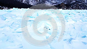 Frozen Lake Baikal, Aerial view. Beautiful winter landscape with clear smooth ice. Famous natural landmark Russia. Blue