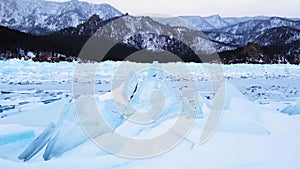 Frozen Lake Baikal, Aerial view. Beautiful winter landscape with clear smooth ice. Famous natural landmark Russia. Blue