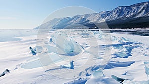 Frozen Lake Baikal, Aerial view. Beautiful winter landscape with clear smooth ice. Famous natural landmark Russia. Blue