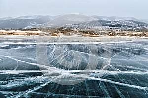 Frozen Lake Baikal. Beautiful mountain near the ice surface on a frosty day. Natural background