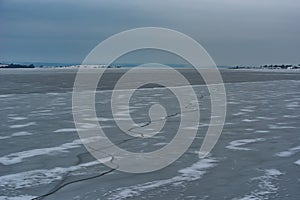 Frozen Lake. Beautiful stratus clouds over the ice surface on a frosty day. Natural background