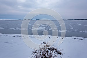 Frozen Lake. Beautiful stratus clouds over the ice surface on a frosty day. Natural background