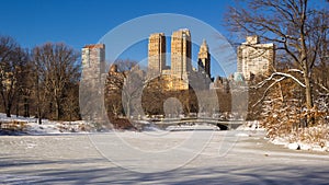 Frozen Lake in Central Park with the Bow Bridge in Winter. Upper West Side, New York City